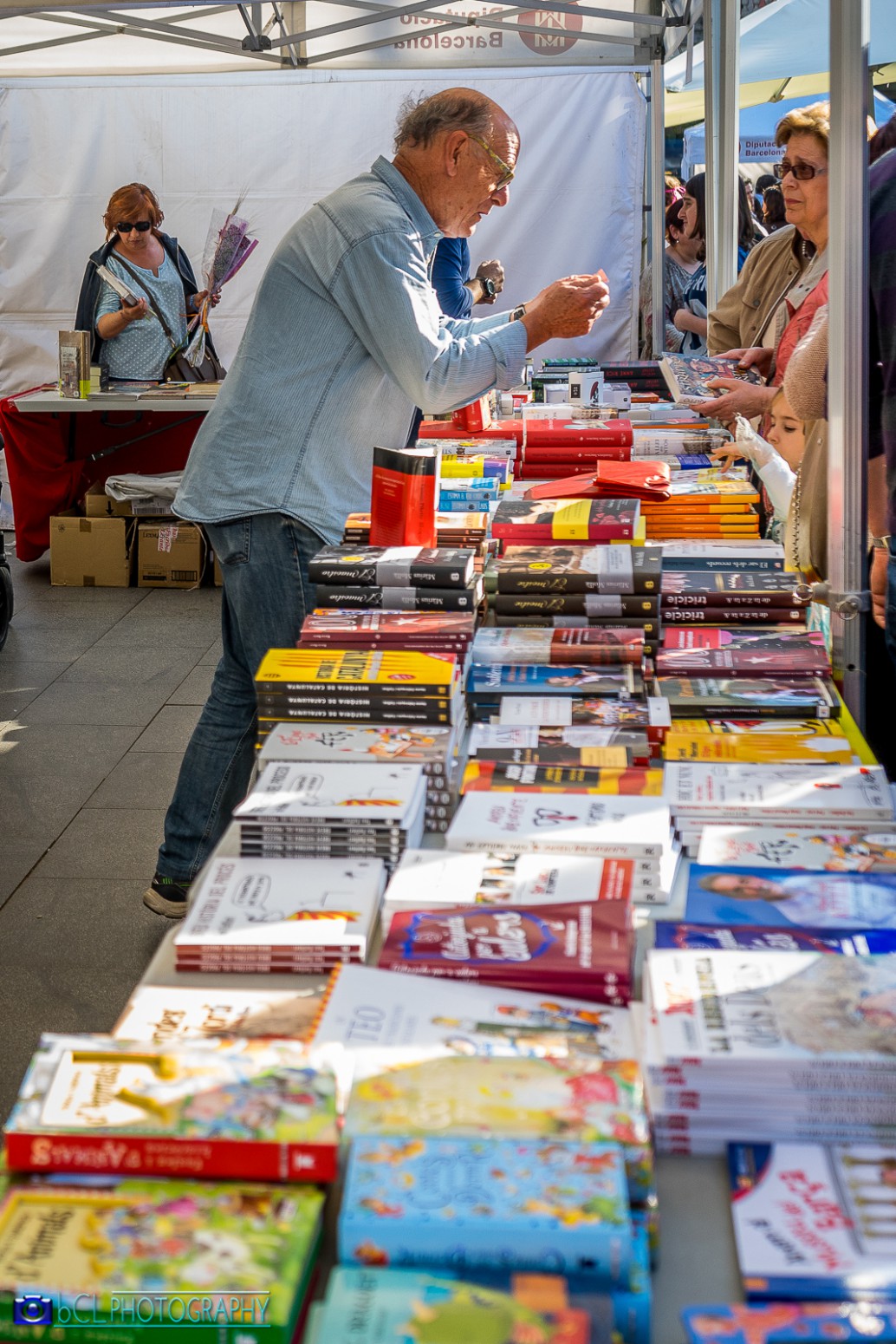 A bookseller advising customers